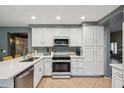 Bright kitchen featuring white cabinets, an island, and tile flooring at 2871 S Los Altos Pl, Chandler, AZ 85286