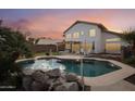 Inviting kidney-shaped pool with a large backyard and patio at 2871 S Los Altos Pl, Chandler, AZ 85286