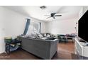 Living room with gray sectional sofa and board games at 5546 W Encanto Blvd, Phoenix, AZ 85035