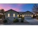 Single-story house with a two-car garage and desert landscaping at 7873 W Fetlock Trl, Peoria, AZ 85383