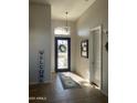 Bright and airy entryway with tile flooring and a view of the front door at 10040 E Grandview St, Mesa, AZ 85207