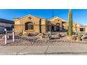 Single-story home with desert landscaping and a large front yard at 10040 E Grandview St, Mesa, AZ 85207