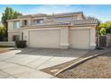 Two-story house with a three-car garage and nicely landscaped front yard at 1021 E Mead Dr, Chandler, AZ 85249