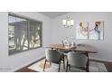 Dining area with wood table and chairs, hardwood floors and large window at 1320 W Palo Verde Dr, Chandler, AZ 85224