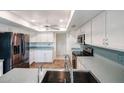 Updated kitchen featuring white cabinetry, stainless steel appliances, and a kitchen sink with modern fixtures at 13359 W Ballad Dr, Sun City West, AZ 85375