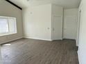 Bright living room with wood floors, lots of light from the window, and two entry doors at 1770 E Sandra Ter, Phoenix, AZ 85022