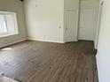 Bright living room with wood floors, lots of light from the window, and two entry doors at 1770 E Sandra Ter, Phoenix, AZ 85022