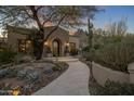 Stone and stucco home with landscaped entry and walkway at 26872 N 102Nd St, Scottsdale, AZ 85262