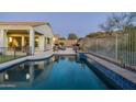 Relaxing backyard oasis with a sparkling pool and a view of the house at 4742 S Primrose Dr, Gold Canyon, AZ 85118