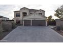 Two-story house with a three-car garage and landscaped front yard at 4913 W Pedro Ln, Laveen, AZ 85339