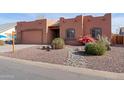 Charming single-story home with a landscaped front yard and a two-car garage at 6131 S Eagle Pass Rd, Gold Canyon, AZ 85118