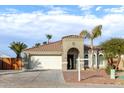 One-story house with a two-car garage, and desert landscaping at 702 E Nancy Ave, San Tan Valley, AZ 85140