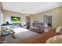 Spacious living room with reclining sofas, a fish tank, and large windows at 10051 S 184Th Dr, Goodyear, AZ 85338