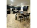 Modern kitchen with dark cabinetry and stainless steel appliances at 12525 W Winslow Ave, Avondale, AZ 85323