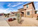 House exterior showing landscaping and a two-car garage at 24758 W Huntington Dr, Buckeye, AZ 85326