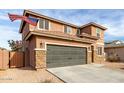 Two-story house with stone accents and a two-car garage at 24758 W Huntington Dr, Buckeye, AZ 85326