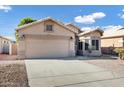 Tan house with a two-car garage and desert landscaping at 2524 N Sunaire --, Mesa, AZ 85215