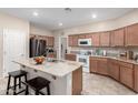 Spacious kitchen with an island, stainless steel appliances, and granite countertops at 27227 N 171St Dr, Surprise, AZ 85387