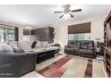 Bright living room with a comfortable sectional sofa and a large TV at 27227 N 171St Dr, Surprise, AZ 85387