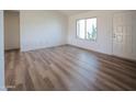 Cozy bedroom featuring new floors, a large window and a neutral color palette at 4709 W Westcott Dr, Glendale, AZ 85308