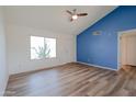 Bright living room offering new floors, a large window and an accent wall at 4709 W Westcott Dr, Glendale, AZ 85308