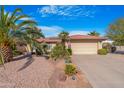 Single-story home with desert landscaping and a two-car garage at 10442 E Flintlock Dr, Sun Lakes, AZ 85248