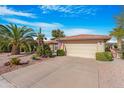 Single-story home with desert landscaping and a two-car garage at 10442 E Flintlock Dr, Sun Lakes, AZ 85248