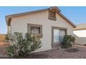 Side view of a single-story house with rock landscaping at 10831 W Laurie Ln, Peoria, AZ 85345