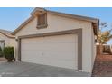 White two-car garage with light-grey trim at 10831 W Laurie Ln, Peoria, AZ 85345