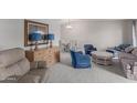 Living room with blue armchairs, plaid couch, and wooden coffee table at 10845 W Kaibab Dr, Sun City, AZ 85373