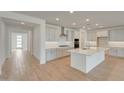 Spacious kitchen featuring white cabinetry, a large island, and stainless steel appliances at 14778 W Tether Trl, Surprise, AZ 85387