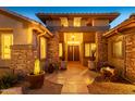 Elegant entryway with double doors and stone accents welcomes you home at 17409 N Horseshoe Dr, Surprise, AZ 85374