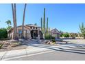 Single-story home with desert landscaping and a large saguaro cactus at 17409 N Horseshoe Dr, Surprise, AZ 85374