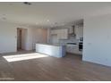 Open concept kitchen with white cabinets, island, and stainless steel appliances at 33333 N 132Nd Dr, Peoria, AZ 85383