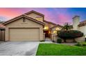 Tan stucco two-story house with a two-car garage and well-manicured lawn at 41 E Caroline Ln, Tempe, AZ 85284