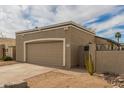 Attached garage with tan door and ample driveway parking at 619 E Jensen St # 55, Mesa, AZ 85203