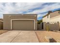 Attached garage with tan door and ample driveway parking at 619 E Jensen St # 55, Mesa, AZ 85203