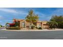 Tan two-story house with a landscaped front yard and a three-car garage at 7710 E Monica Dr, Scottsdale, AZ 85255