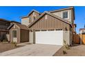 Two-story house with a white garage door and brown accents at 9242 E Sector Dr, Mesa, AZ 85212