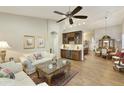 Bright living room featuring hardwood floors and comfy sofas at 9634 E Rocky Lake Dr, Sun Lakes, AZ 85248