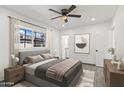 Bright bedroom featuring a ceiling fan, window with natural light, and simple, yet stylish decor at 102 W Maryland Ave # F1, Phoenix, AZ 85013