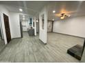 View of the open-concept living area with a kitchen and fireplace at 102 W Maryland Ave # F1, Phoenix, AZ 85013