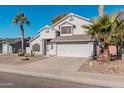 Two-story house with a white exterior, two-car garage, and palm trees at 1628 E Kent Ave, Chandler, AZ 85225