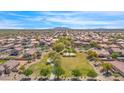 Aerial view of community featuring homes, green spaces, and mountain views at 1650 E Kingman Pl, Casa Grande, AZ 85122