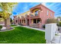 Community view of townhomes with lush landscaping and a grassy lawn at 21655 N 36Th Ave # 117, Glendale, AZ 85308