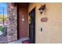 Inviting entryway with a black wrought iron door and a stone accent wall at 21655 N 36Th Ave # 117, Glendale, AZ 85308