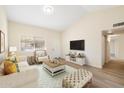 Bright living room featuring a comfy sofa and a large TV at 2610 E Contessa St, Mesa, AZ 85213