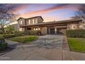 Elegant two-story home featuring stone accents, a porte cochere, and a meticulously landscaped front yard at 3428 N Park St, Buckeye, AZ 85396
