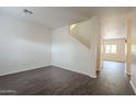 Living room with dark wood floors and staircase at 9202 W Cambridge Ave, Phoenix, AZ 85037
