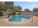 Inviting kidney shaped pool with a concrete deck at 9202 W Cambridge Ave, Phoenix, AZ 85037